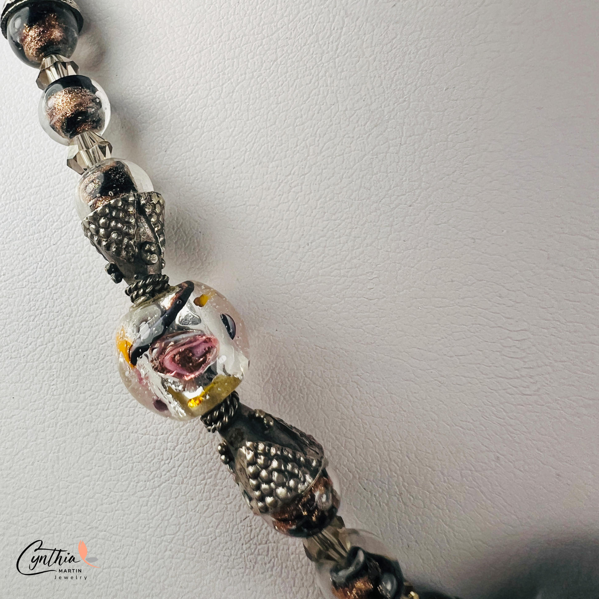 Necklace featuring exquisite Murano blown glass focal beads surrounded by intricate copper-swirled lampwork beads, 15 inches with a 2-inch extender.