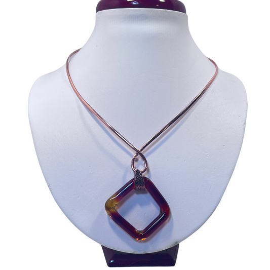 Copper neck collar holding amber square blown glass pendant by Wisconsin artist Tammy Rae, blending artistry with craftsmanship.