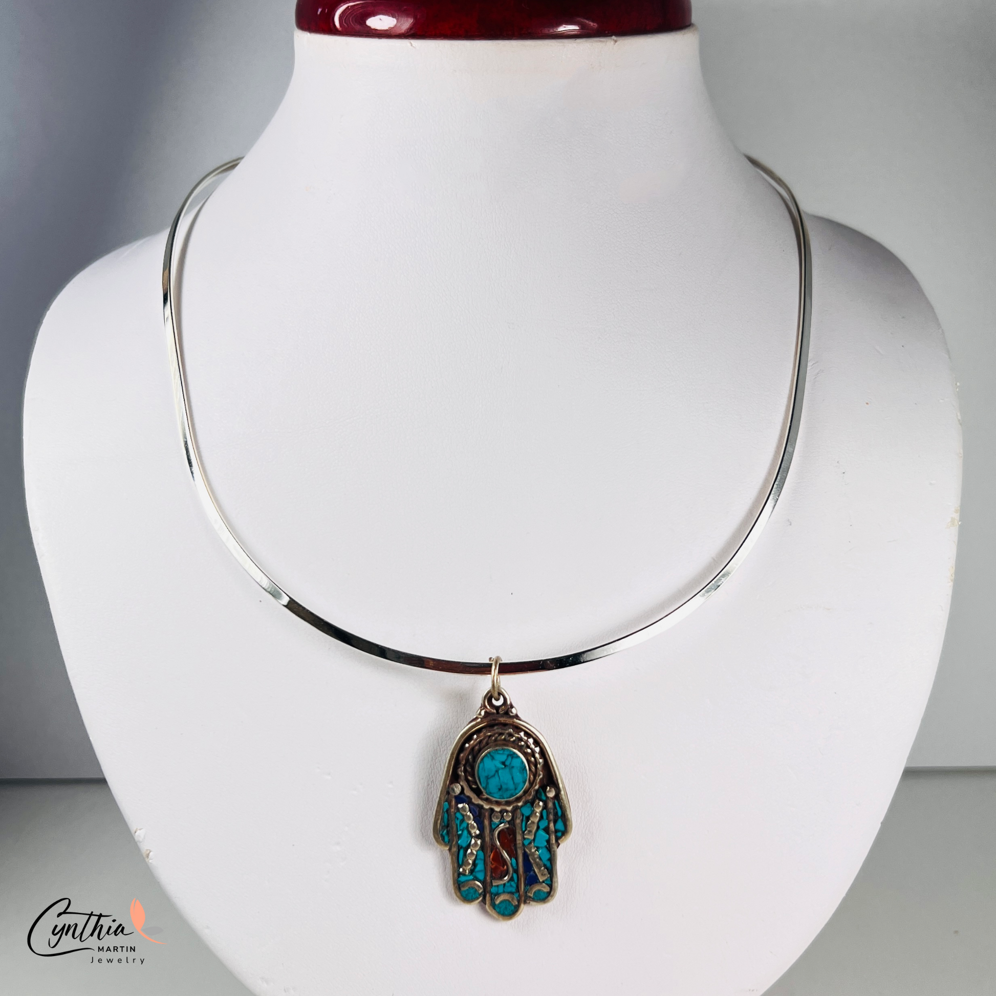 Stylish Hamsa hand choker necklace symbolizing protection, with an upward-facing design that wards off negative emotions.