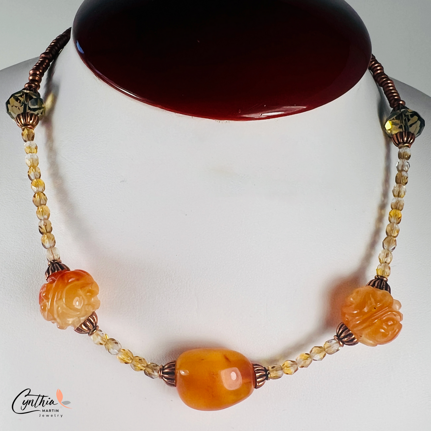 Striking necklace featuring rich Baltic amber, etched milky orange Indonesian stones, green faceted beads, and copper accents, 15 inches with a 2-inch extender.