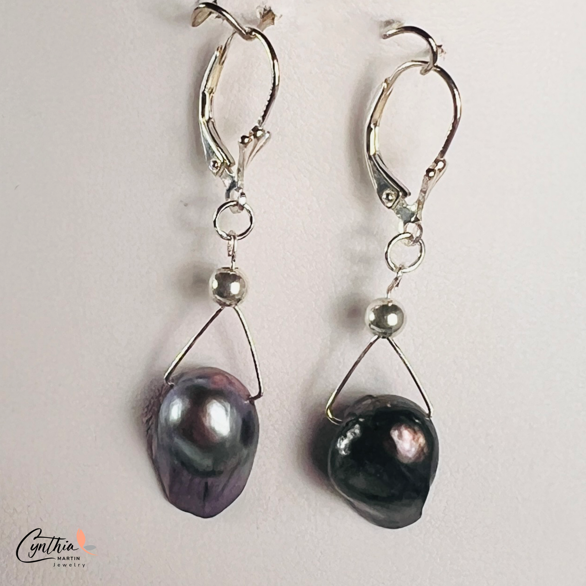 Earrings featuring exclusive dark plum freshwater pearls with elegant silver Bali bead spacers, 1 inch in height.