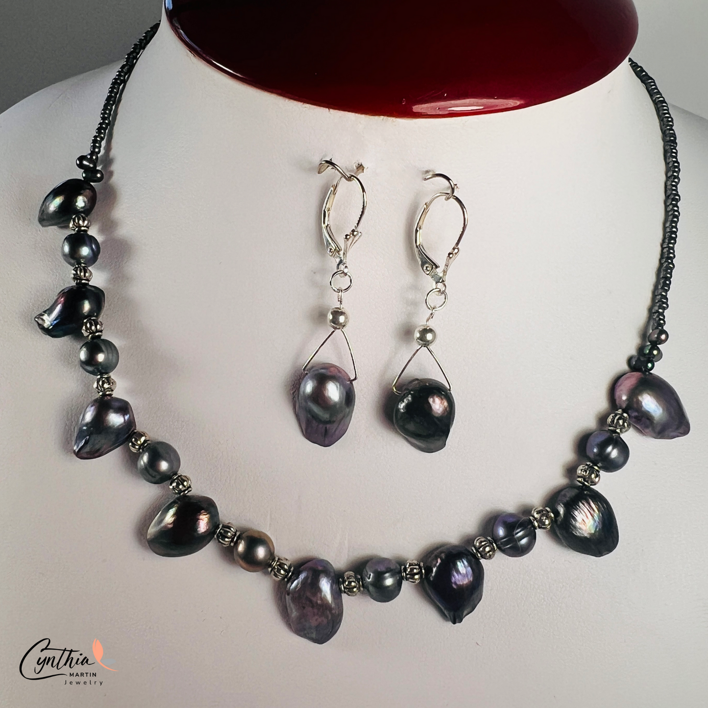 Necklace featuring exclusive dark plum freshwater pearls with silver Bali bead spacers, measuring 15 inches with a 2-inch extender.