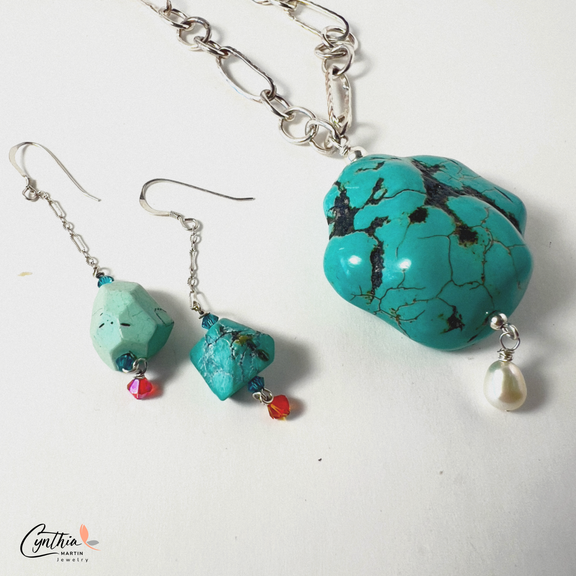 Earrings with authentic turquoise nuggets on a short .75-inch chain, dangling from sterling silver ear wires.