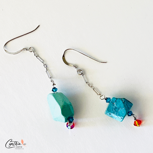 Earrings with authentic turquoise nuggets on a short .75-inch chain, dangling from sterling silver ear wires.