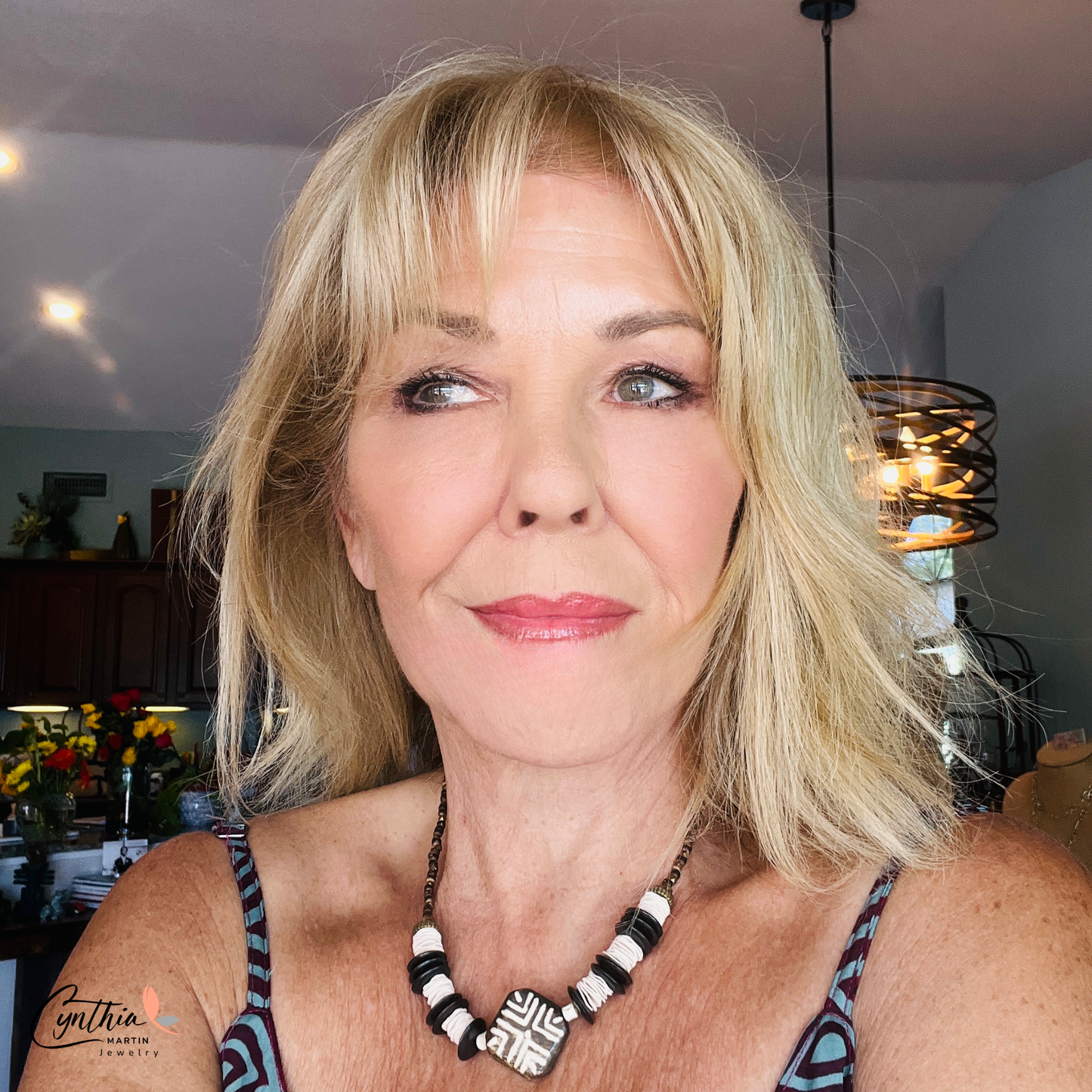 Hand-painted African tribal wooden focal bead necklace with black wooden discs, white paper beads, brown stones, and brass faceted beads, 15 inches with 2-inch extender.