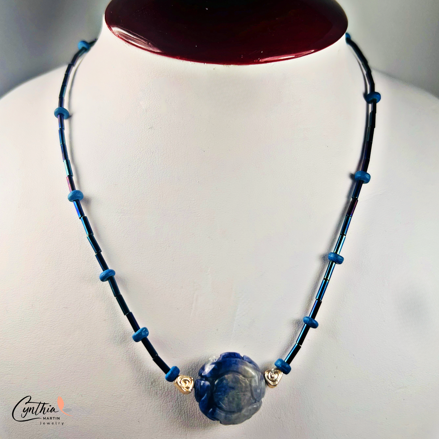 Dainty necklace featuring an Indonesian etched milky dark blue stone focal bead with cobalt blue and ultramarine tube beads, 15 inches with 2-inch extender.