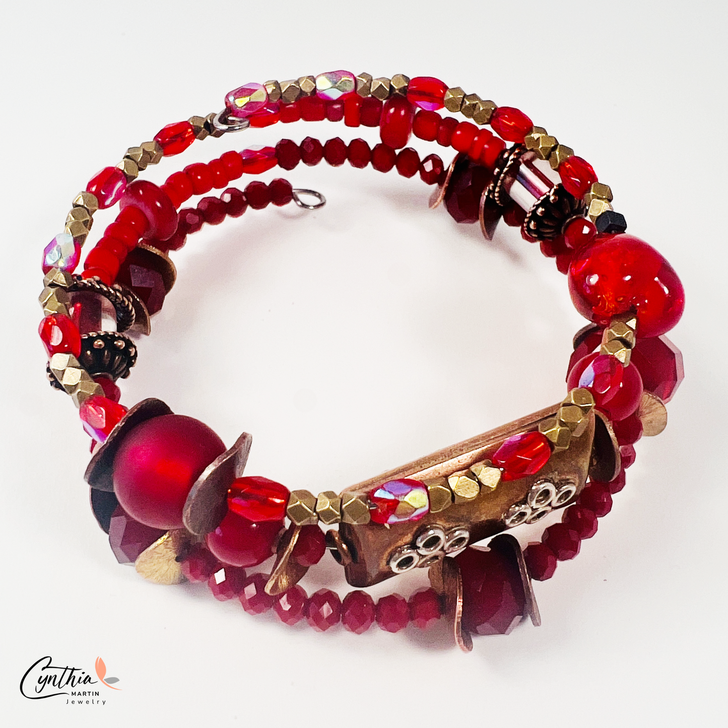 Three-layer wrap bracelet featuring deep red faceted beads and elegant copper spacers, designed for vibrant style.