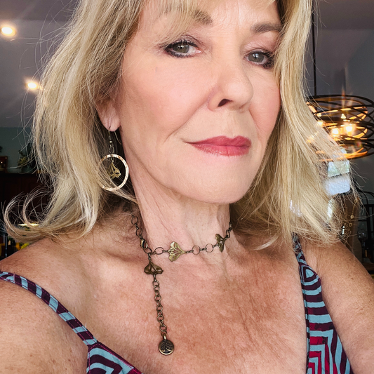 Delicate Art Nouveau-inspired earrings featuring sun-kissed garden flowers suspended in a 1.5-inch hammered gold loop, part of a unique jewelry set.