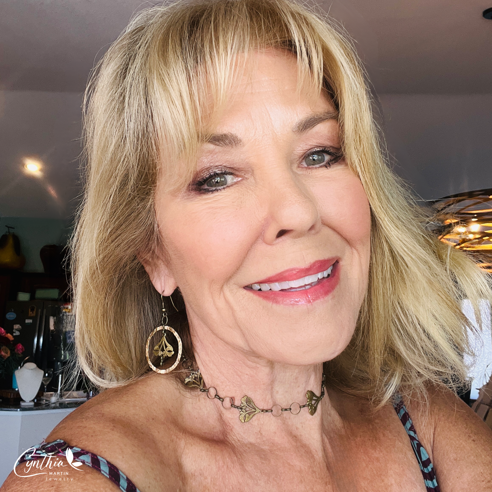 Delicate Art Nouveau-inspired earrings featuring sun-kissed garden flowers suspended in a 1.5-inch hammered gold loop, part of a unique jewelry set.