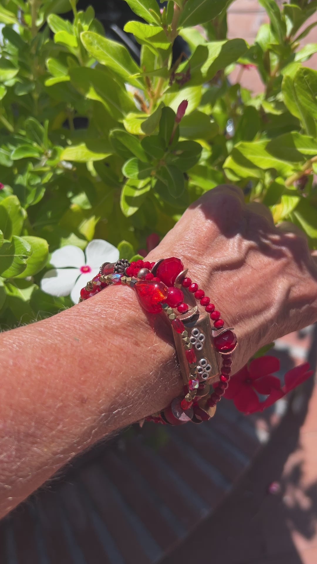 Three-layer wrap bracelet featuring deep red faceted beads and elegant copper spacers, designed for vibrant style.
