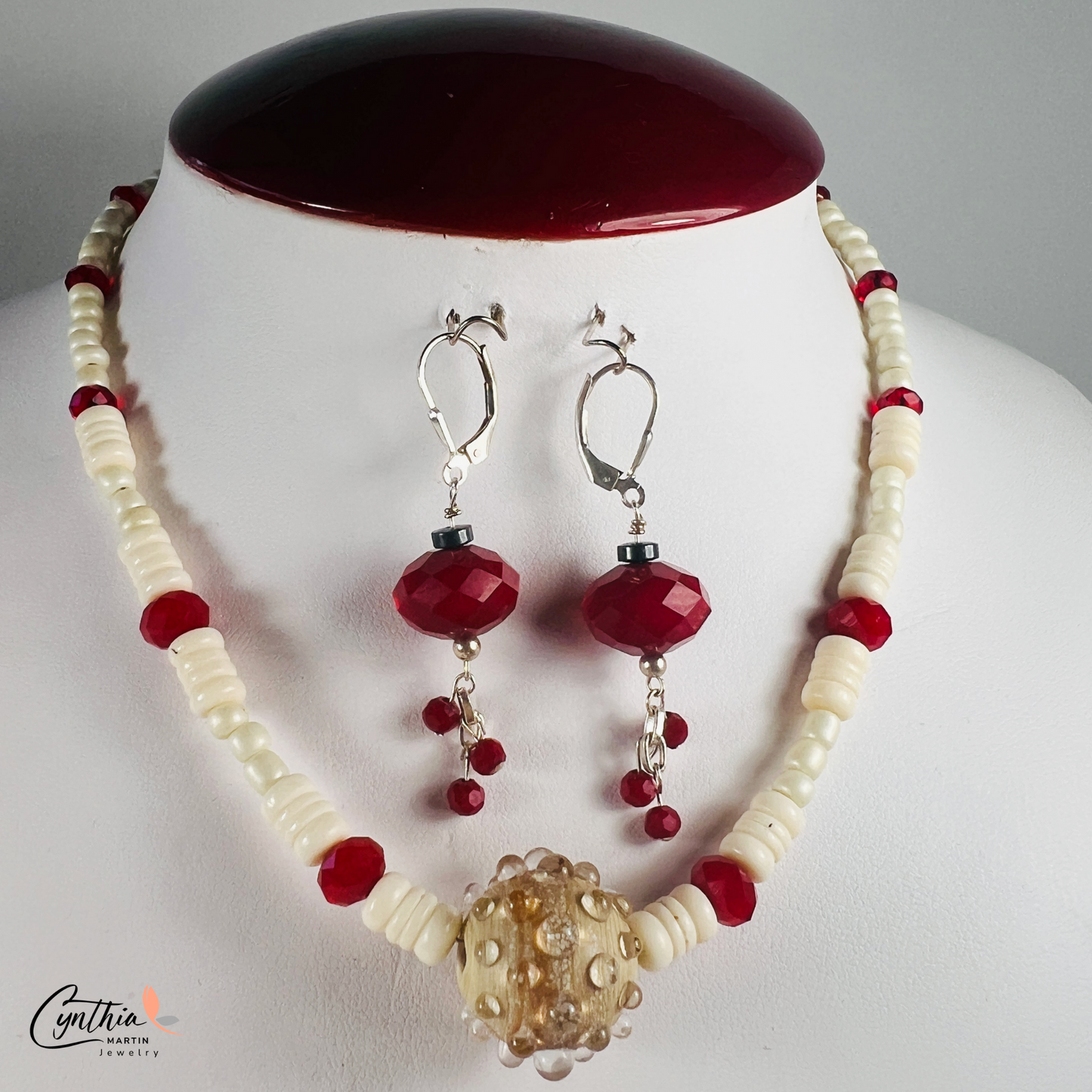 Hand-crafted ceramic bead necklace with glossy white beads, ruby-red rondelles, and white bone heishi beads, 15 inches with 2-inch extender.