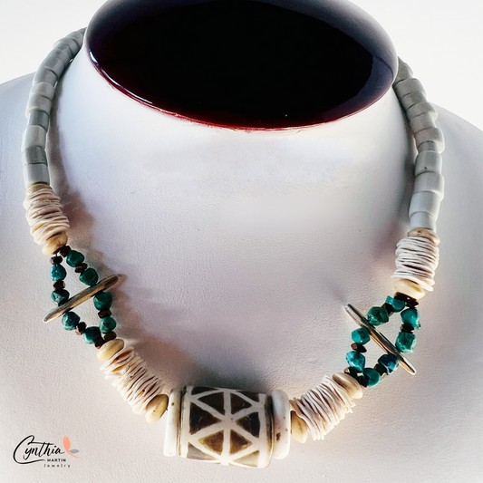 Bold necklace featuring a hand-painted African tribal wooden focal bead, turquoise nuggets, and bone Heishi beads, 15 inches with a 2-inch extender.