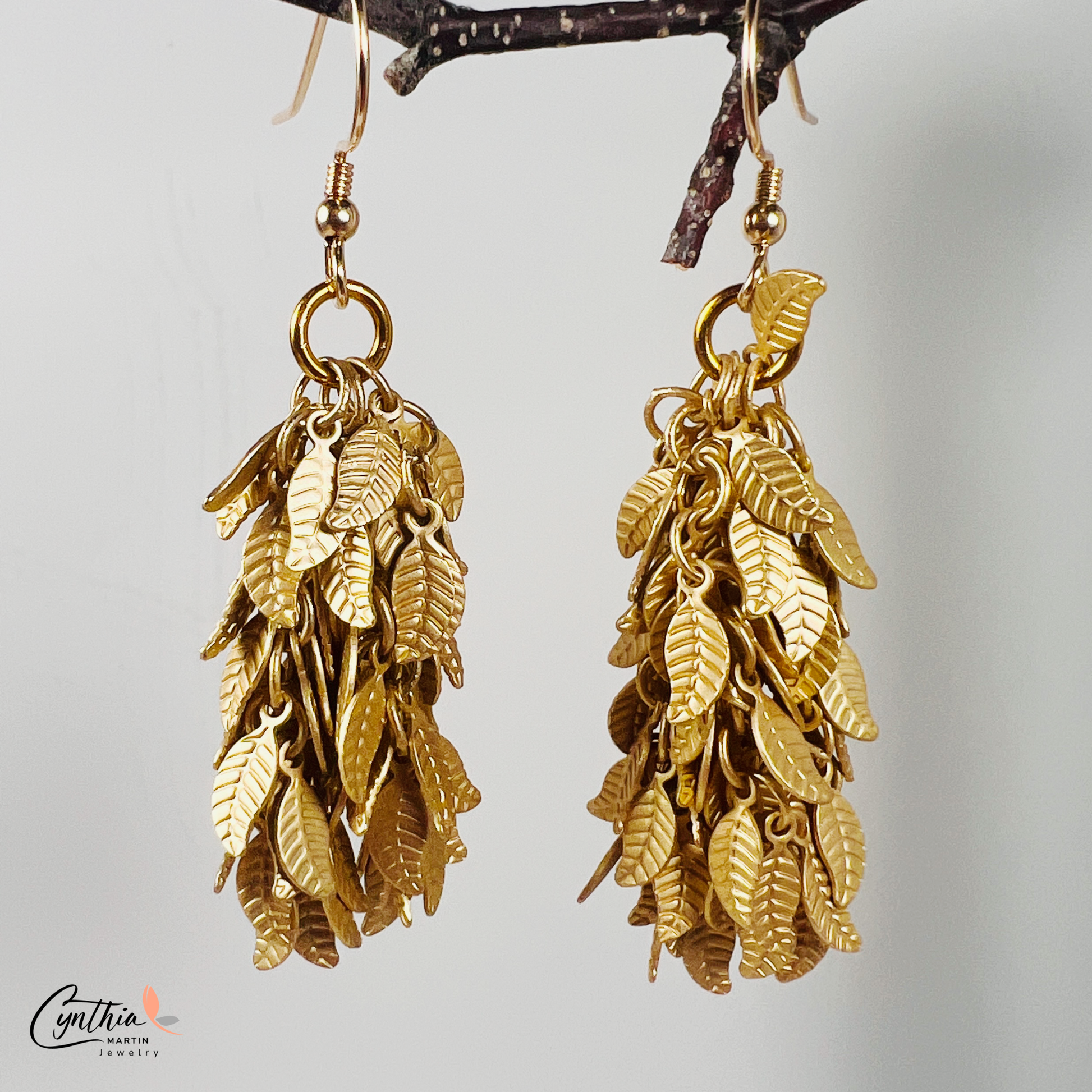 Charming earrings featuring clusters of tiny leaves that sway with movement, creating a delicate statement.