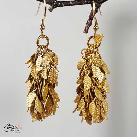 Charming earrings featuring clusters of tiny leaves that sway with movement, creating a delicate statement.
