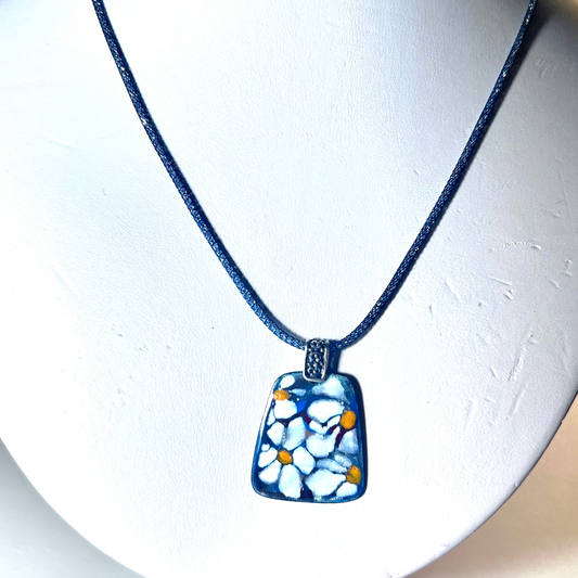 Exquisite pendant with white flower design in enamel, featuring sgraffito technique and hand-painted details, on a 16-inch Italian mesh necklace.