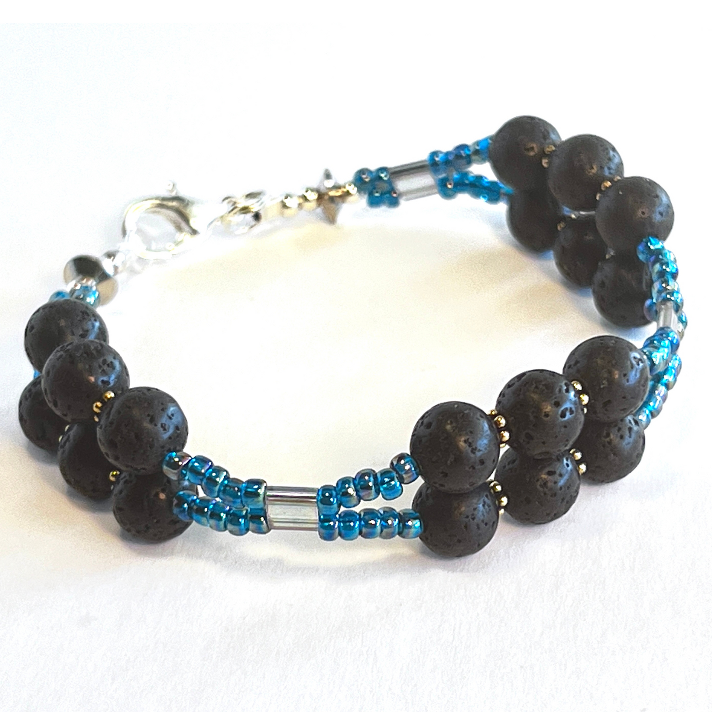 Double-strand gemstone bracelet featuring black lava rock beads and vivid blue seed beads, secured with a sleek lobster clasp