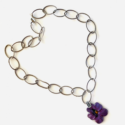 Bold purple daisy enamel pendant on an 18-inch sterling silver chain.