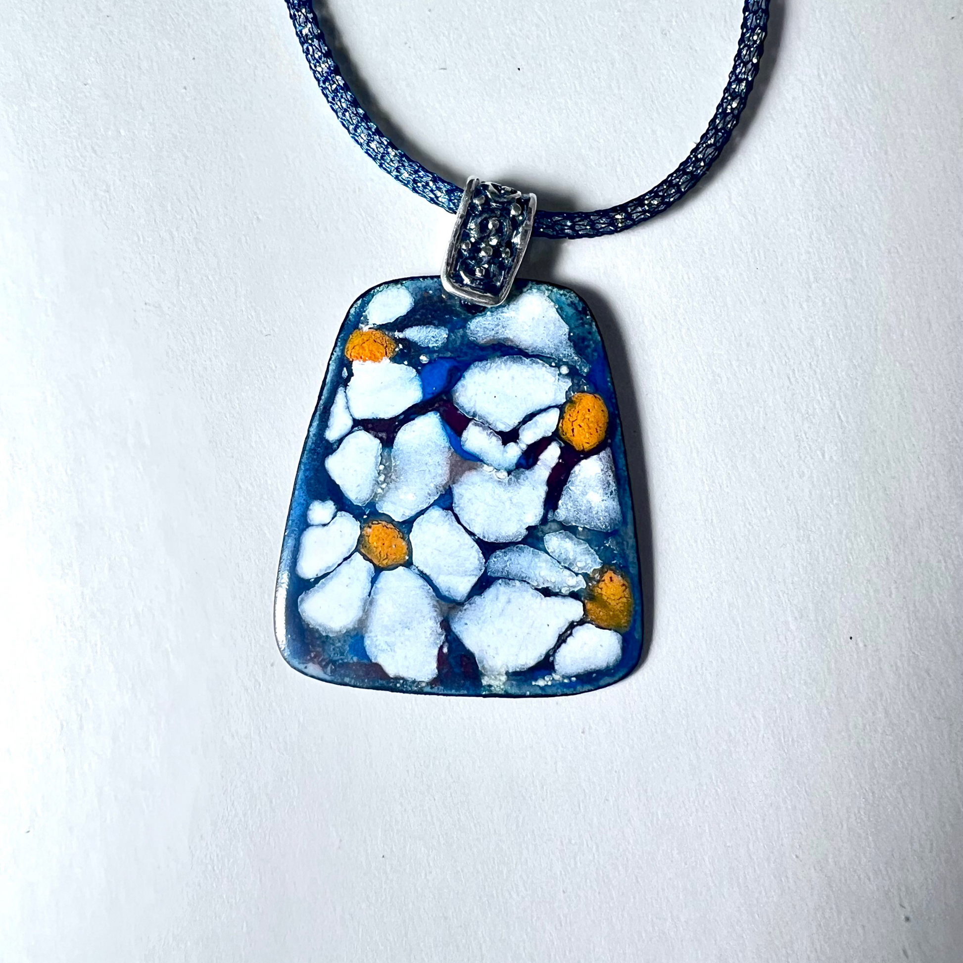 Exquisite pendant with white flower design in enamel, featuring sgraffito technique and hand-painted details, on a 16-inch Italian mesh necklace.