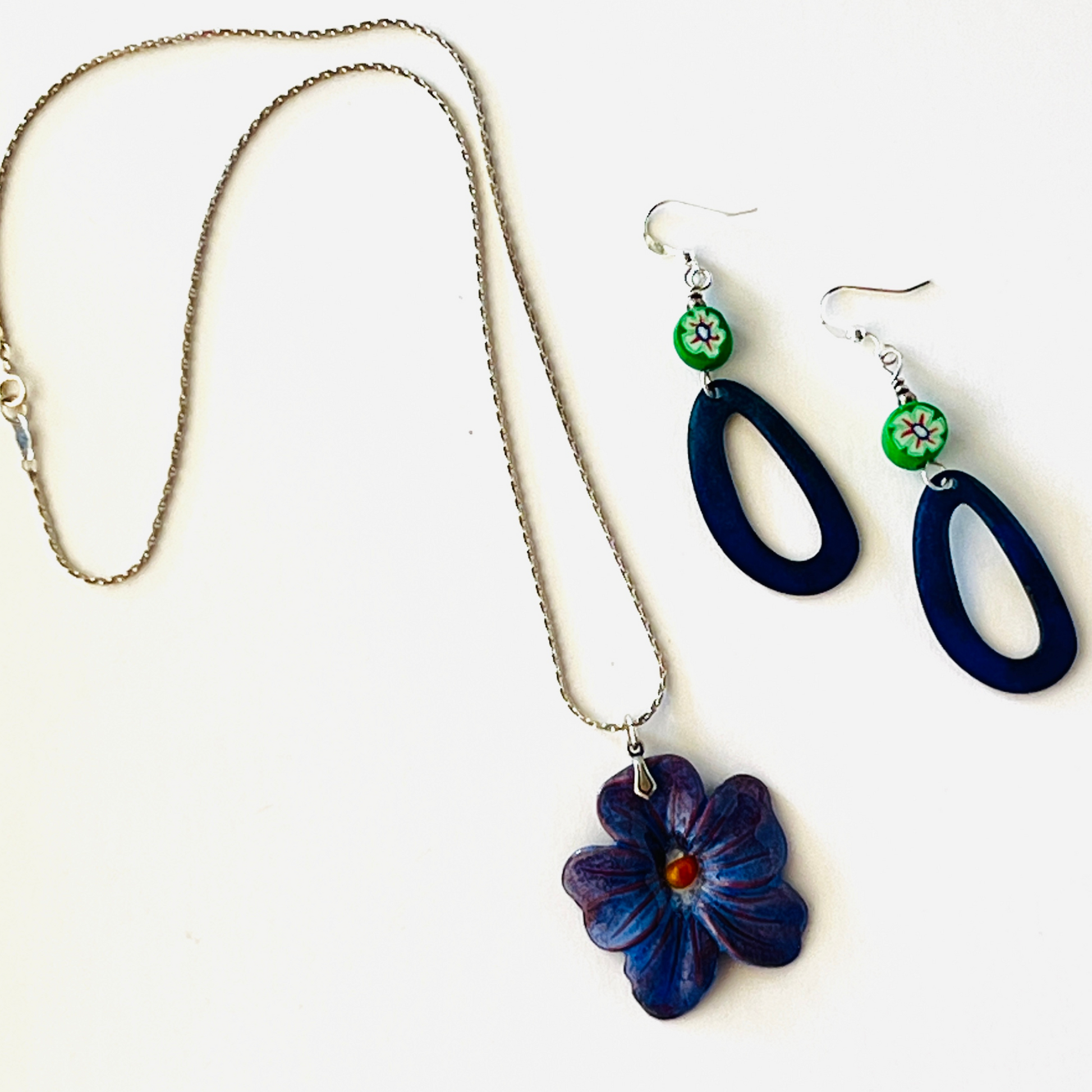 Deep blue enamel pansy pendant on a 16-inch sterling silver chain.