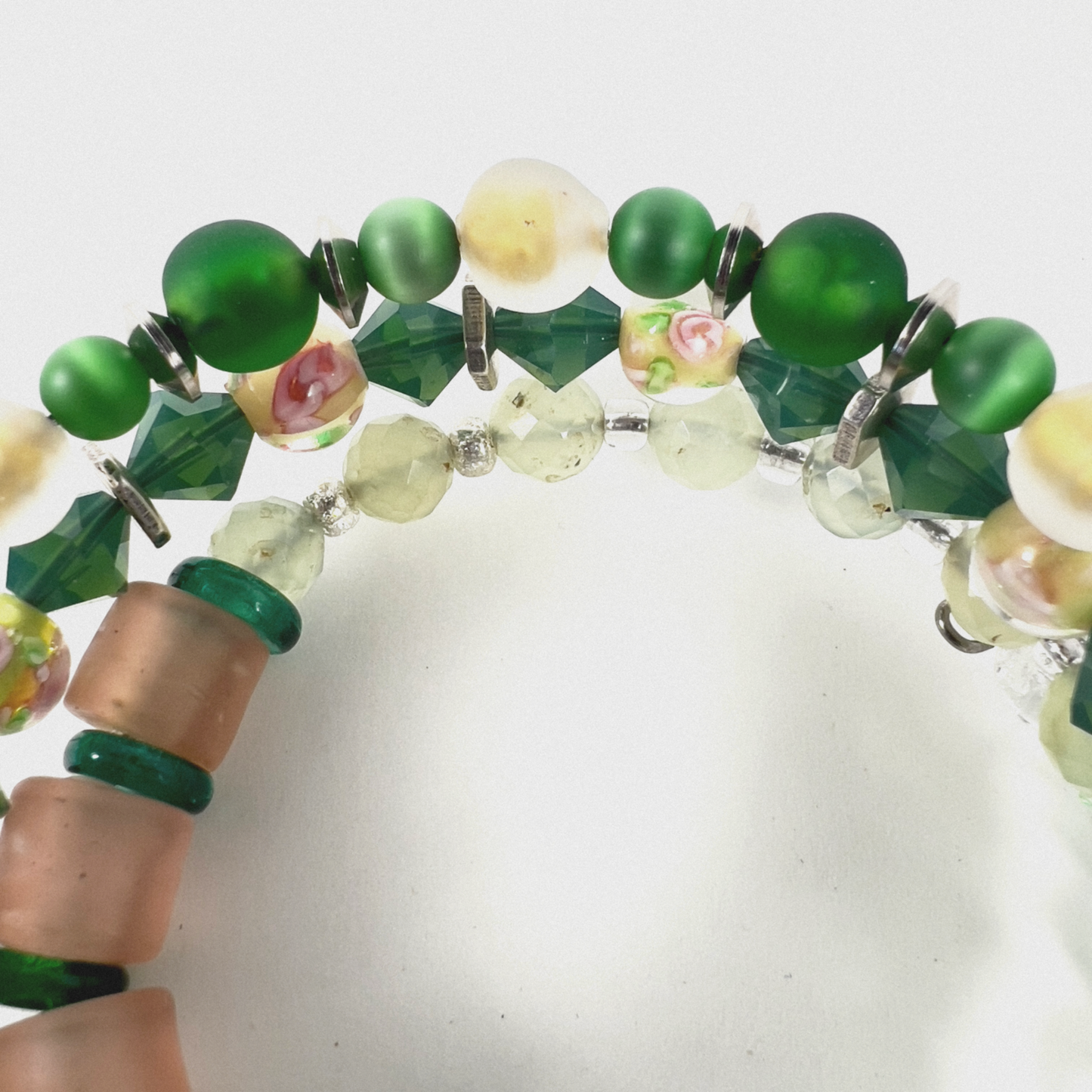 Multi-wrap bracelet featuring peach and green beads, sterling silver spacers, green cat-eye 4mm beads, sparkling transparent crystals, and 4mm beads with pink flower designs.