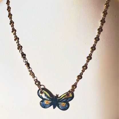 Gold small link chain with hand-painted enamel monarch butterfly pendant, blending luxury with the intricate beauty of nature.