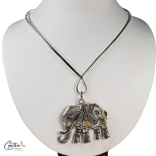 Elegant sterling silver elephant necklace with traditional Indian markings, symbolizing strength and determination.
