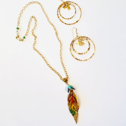 Dainty gold chained necklace adorned with a pair of leaves