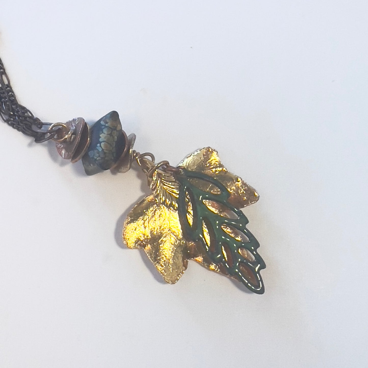 Brass multi-chain necklace with gold Aspen leaf and enameled tri-colored leaf, finished with handmade bead by Tucson Bead Artist Tennessa Mclean