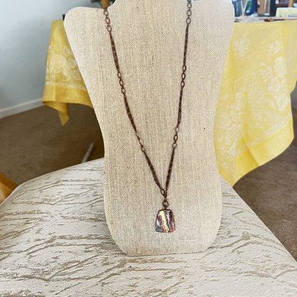 Multi-strand necklace with gold foil accents, copper pendant, and dark bronze chain, featuring an easily adjustable design and removable magnetic clasp.