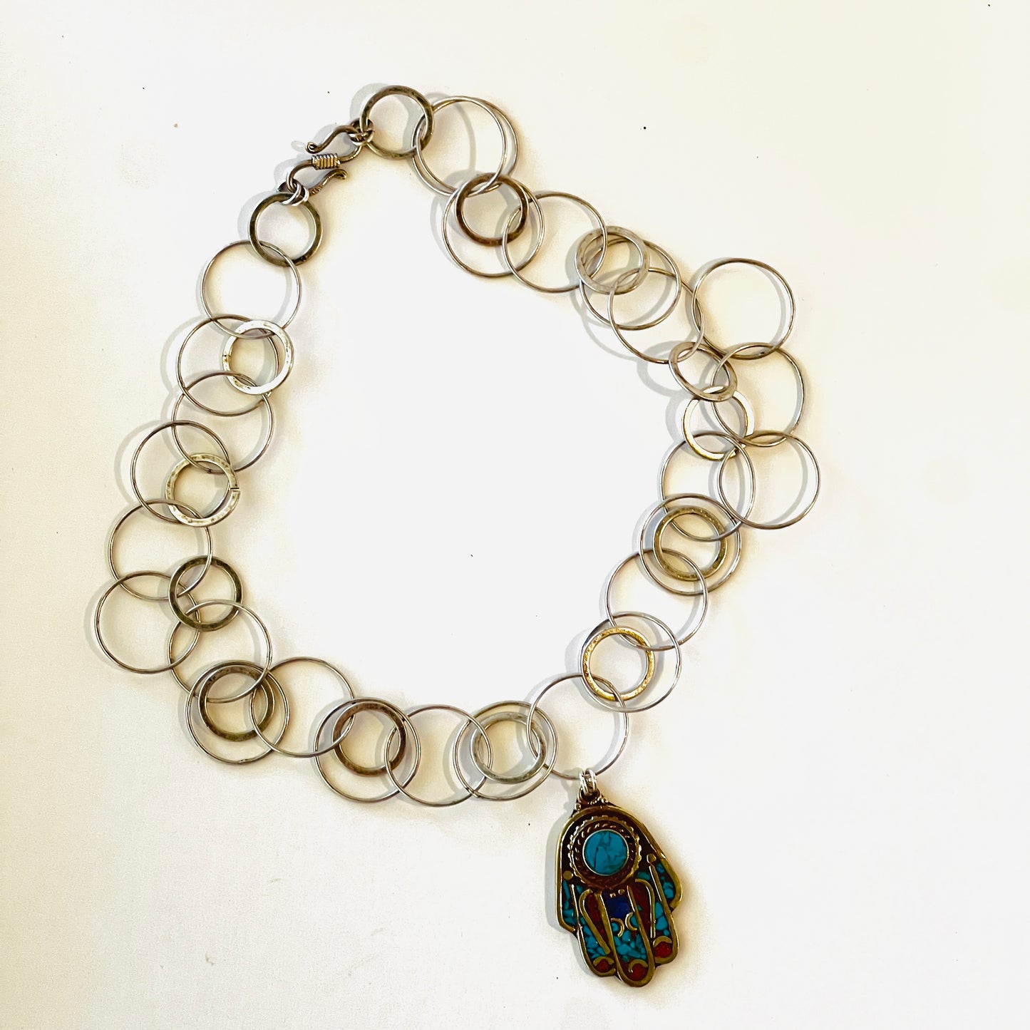 Hand of Fatima good luck charm crafted in silver with turquoise and coral inlays, featuring a multi-ringed chain