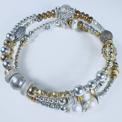 Elegant bracelet with pearls, crystal rondelles, spheres, pave barrel beads, and silver and gold beads in multiple sizes, ideal for stacking and special occasions.