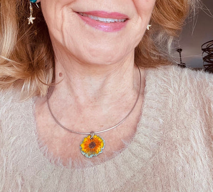 Hand-painted sunflower pendant with vitreous enamel on .999 fine silver, featuring a leaf-shaped sterling silver bail and adjustable omega chain.