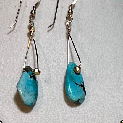 Graduated sizes of authentic turquoise with gold spacers and chains necklace.