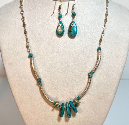 Elegant gold chain necklace with etched gold tubing, adorned with three sliced authentic turquoise pieces.