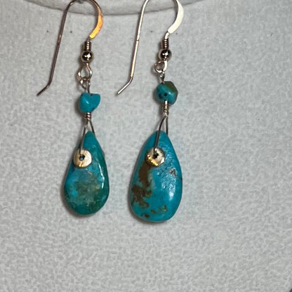 Delicately shaped oval turquoise and gold pendant, a sophisticated upgrade from traditional silver and turquoise.