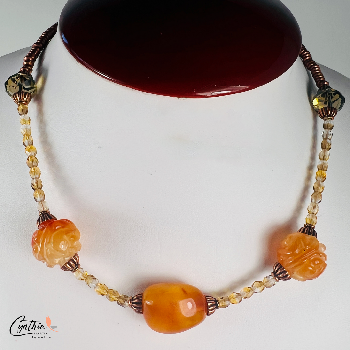 Striking necklace featuring rich Baltic amber, etched milky orange Indonesian stones, green faceted beads, and copper accents, 15 inches with a 2-inch extender.
