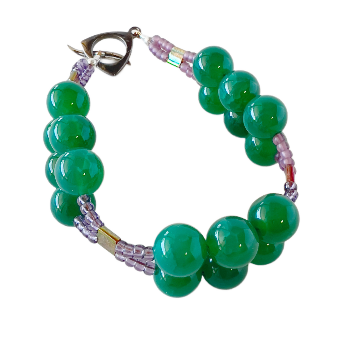 Charming double-strand bracelet featuring dark green quartz beads accented with purple seed beads, secured with a stylish toggle clasp