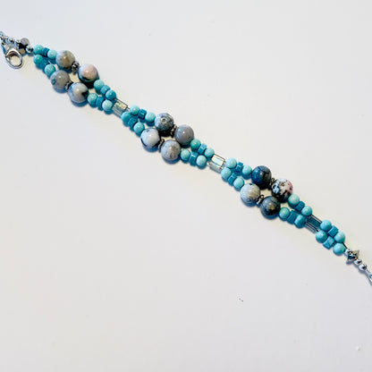 Double-strand gemstone bracelet featuring smoky quartz, turquoise beads, and spacers, secured with a lobster clasp