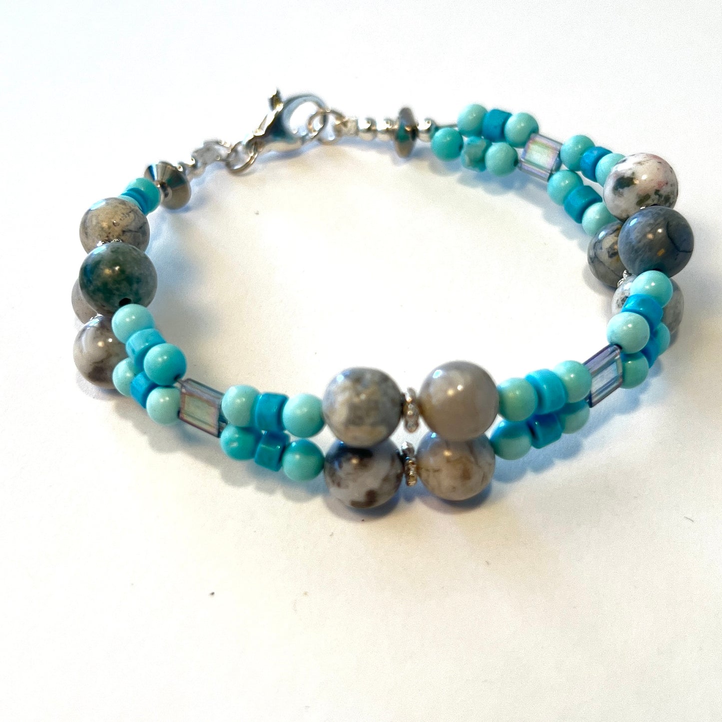 Double-strand gemstone bracelet featuring smoky quartz, turquoise beads, and spacers, secured with a lobster clasp