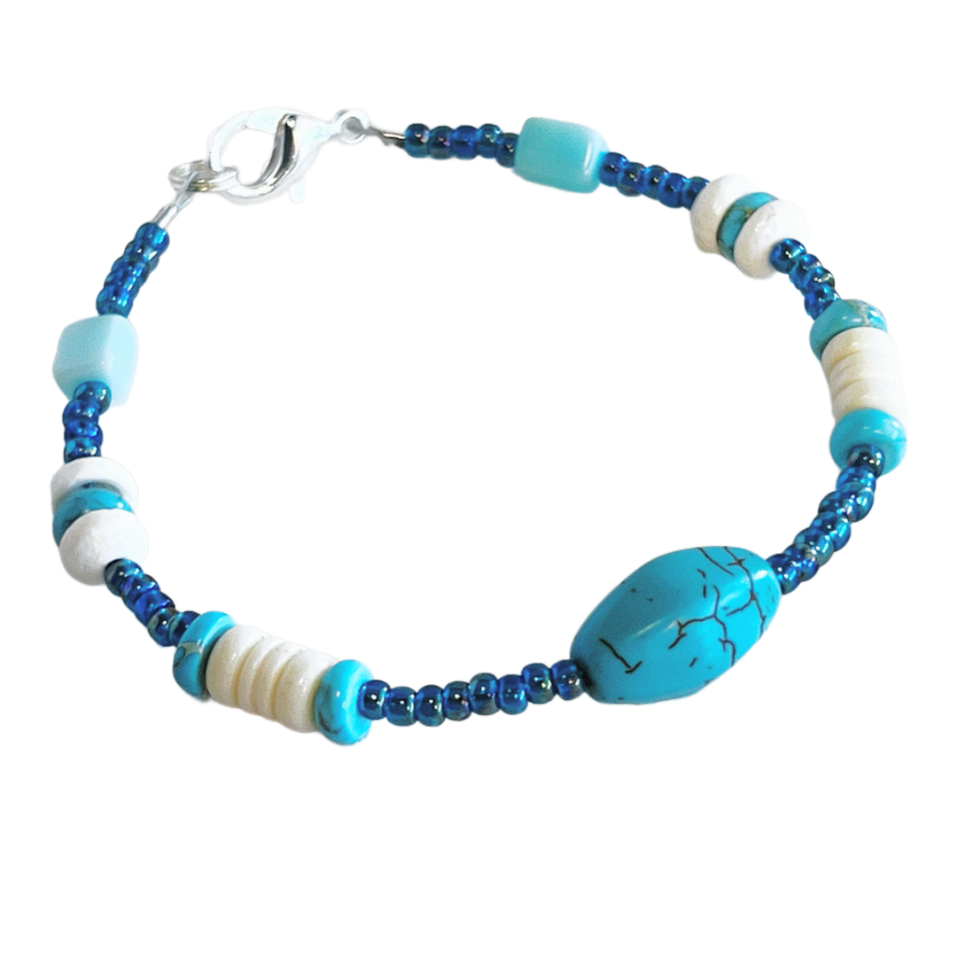 Single-strand bracelet featuring turquoise beads in various sizes, accented with blue seed beads, secured with a lobster clasp