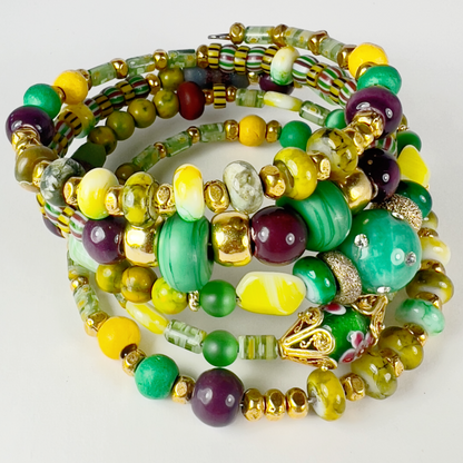 Festive green, yellow, and gold 5-layer bracelet with gold-filled spacers, millefiori green tubes, crystal sphere beads, and agate brown beads, perfect for Mardi Gras celebrations.