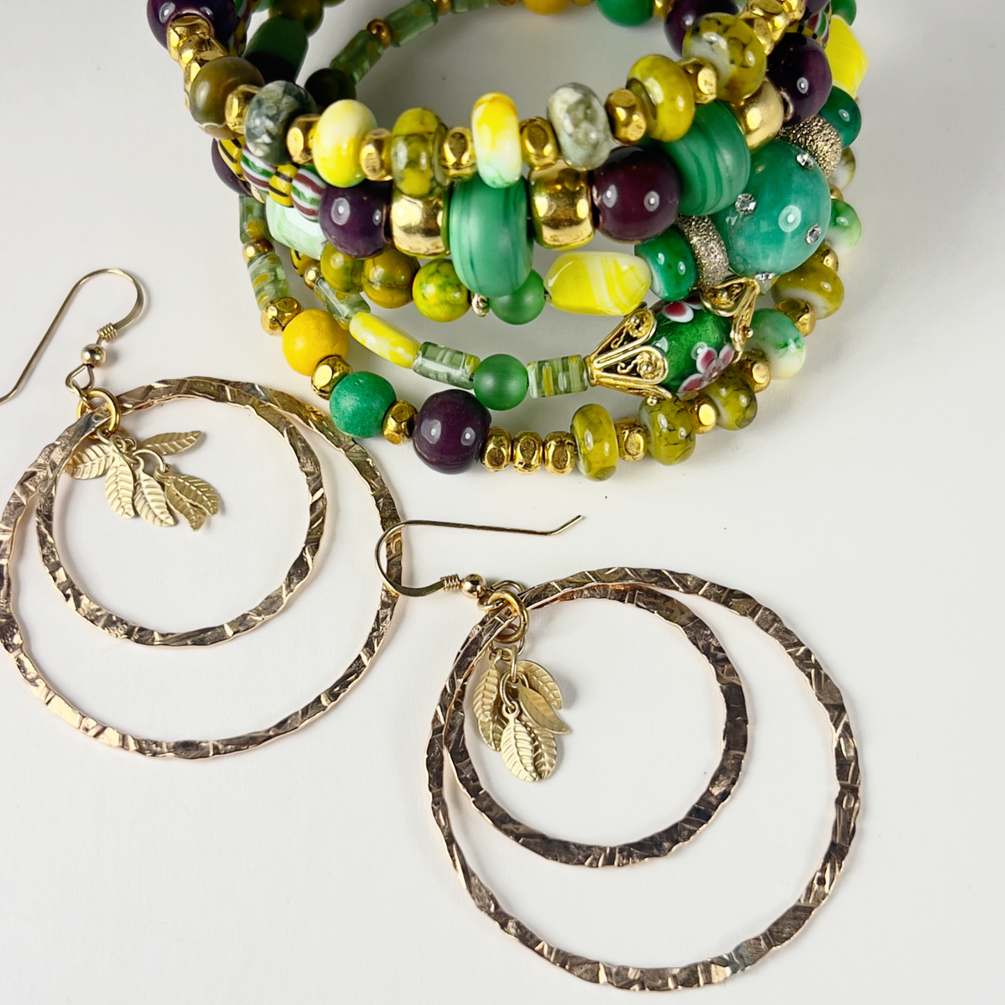 Festive green, yellow, and gold 5-layer bracelet with gold-filled spacers, millefiori green tubes, crystal sphere beads, and agate brown beads, perfect for Mardi Gras celebrations.