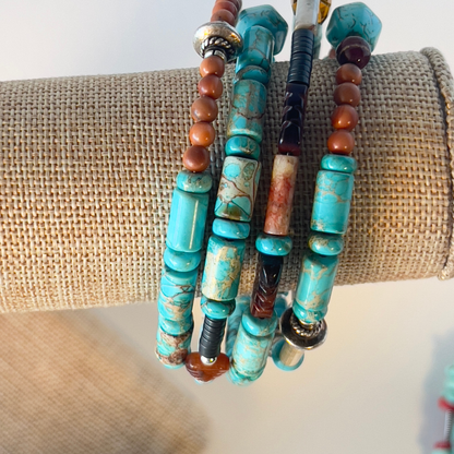 This is a naturally elegant wrap bracelet with hand-polished brilliant turquoise tubes and rondelle spacers. Designed with beautiful turquoise colors, coral, and brown and cream high-polished agate and glass. Silver metal, one size fits all.