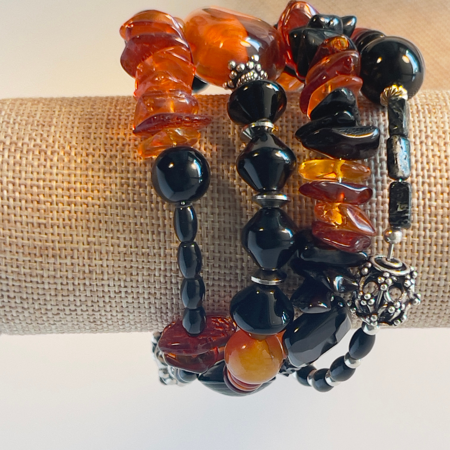 Stunning wrap bracelet with an amazing Baltic Sea amber nugget focal bead, multiple large chips of amber, black and amber rondelle spacers, and black onyx beads in round and diamond shapes. Silver metal, one size fits all.