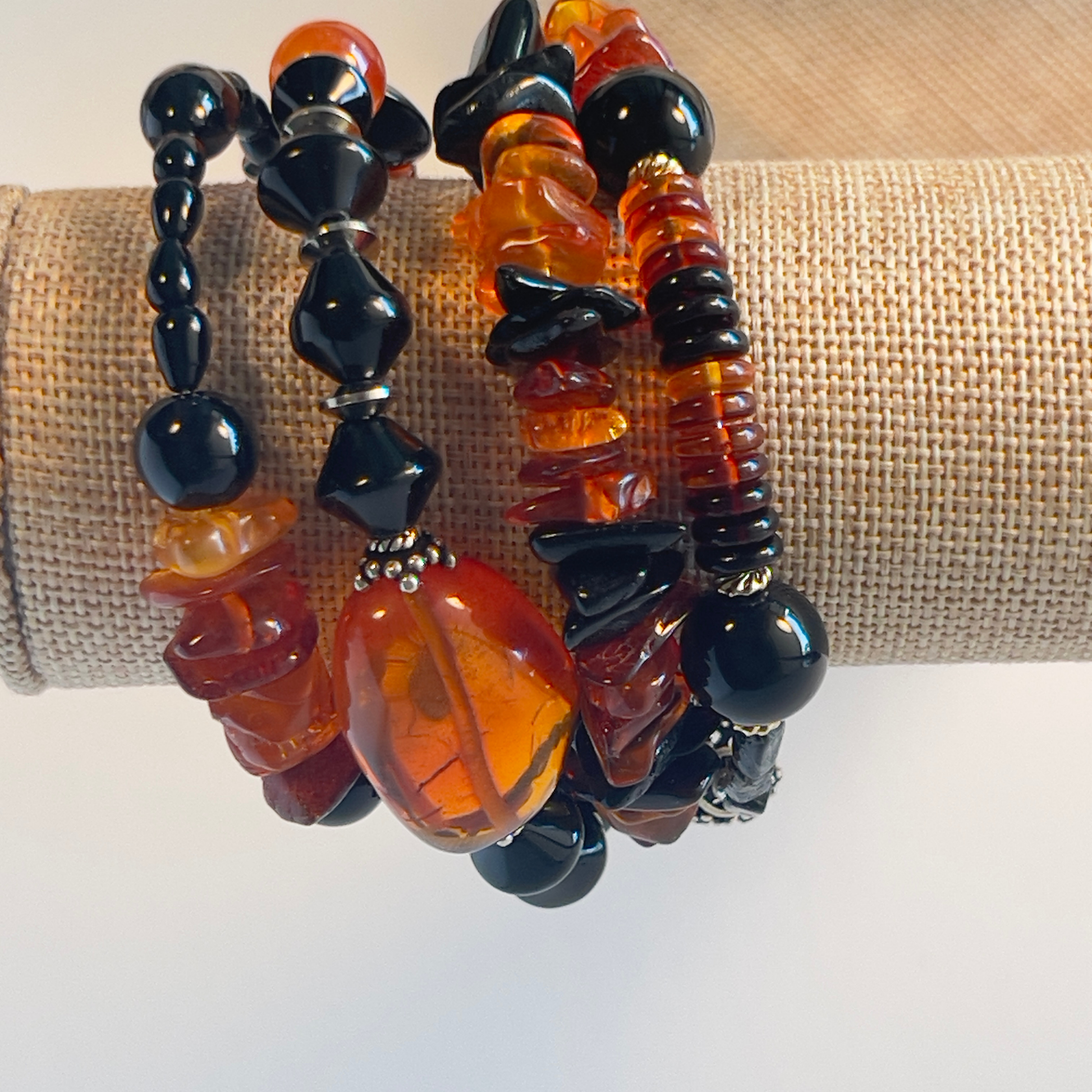 Stunning wrap bracelet with an amazing Baltic Sea amber nugget focal bead, multiple large chips of amber, black and amber rondelle spacers, and black onyx beads in round and diamond shapes. Silver metal, one size fits all.