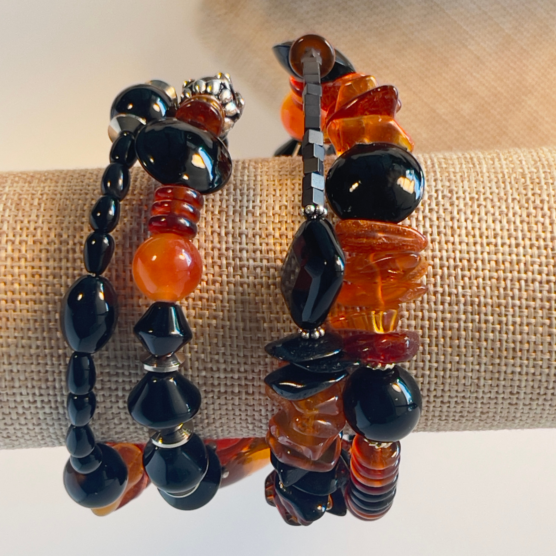 Stunning wrap bracelet with an amazing Baltic Sea amber nugget focal bead, multiple large chips of amber, black and amber rondelle spacers, and black onyx beads in round and diamond shapes. Silver metal, one size fits all.