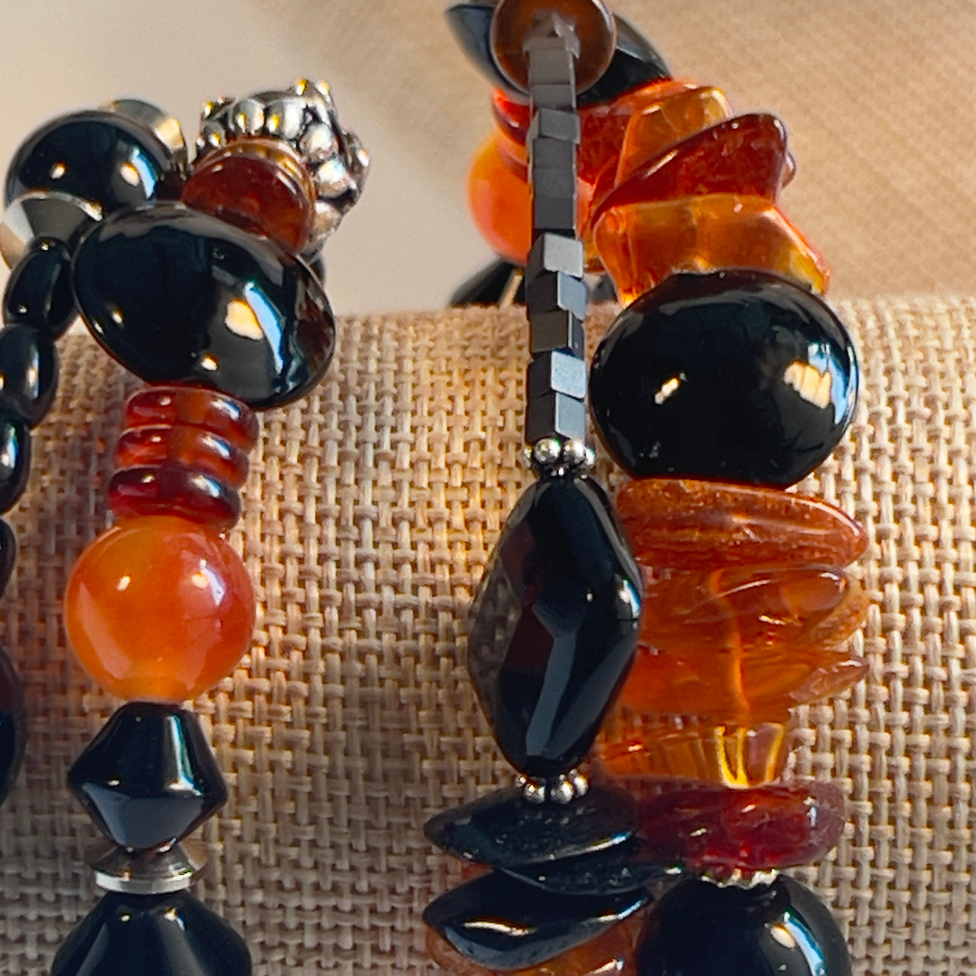 Stunning wrap bracelet with an amazing Baltic Sea amber nugget focal bead, multiple large chips of amber, black and amber rondelle spacers, and black onyx beads in round and diamond shapes. Silver metal, one size fits all.