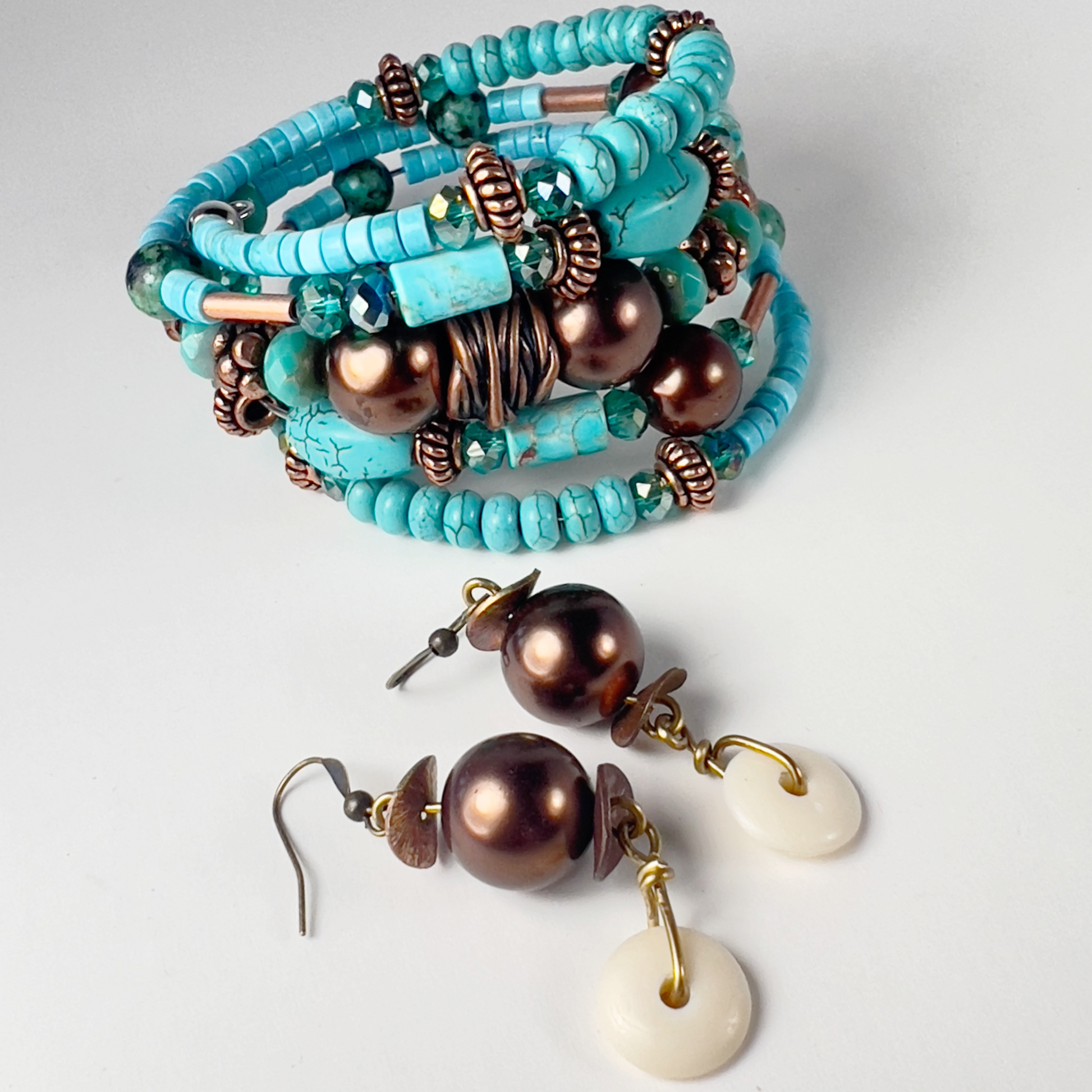 Naturally elegant 5-wrap bracelet with uniform chiseled turquoise tubes, rondelle spacers, bold bronze polished beads, and spacers. Designed to contrast turquoise and brass beautifully.