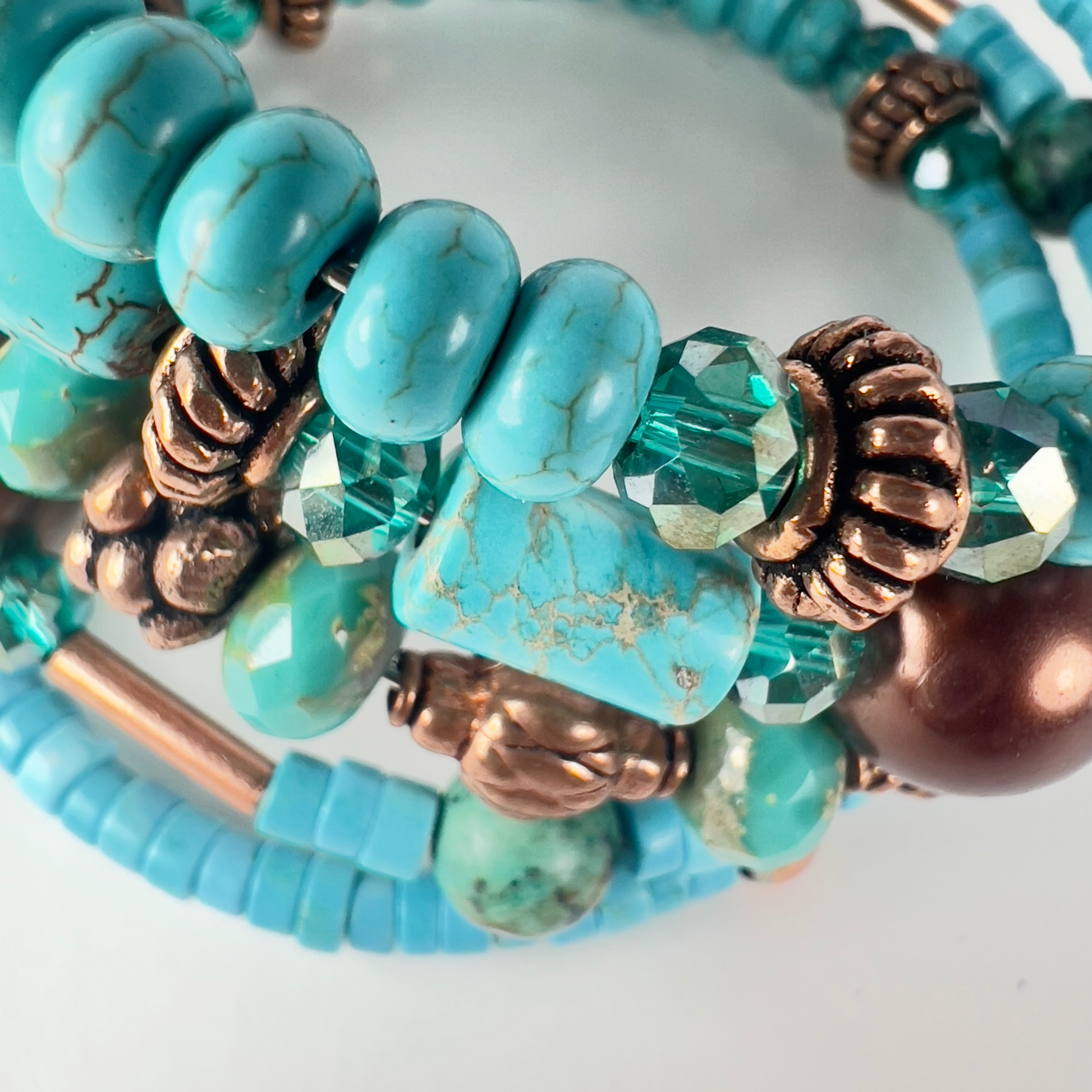 Naturally elegant 5-wrap bracelet with uniform chiseled turquoise tubes, rondelle spacers, bold bronze polished beads, and spacers. Designed to contrast turquoise and brass beautifully.