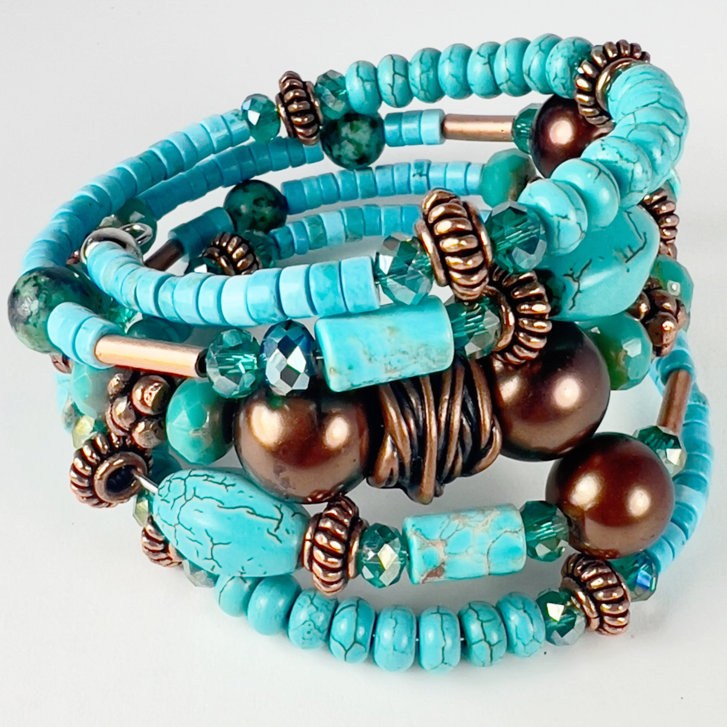 Naturally elegant 5-wrap bracelet with uniform chiseled turquoise tubes, rondelle spacers, bold bronze polished beads, and spacers. Designed to contrast turquoise and brass beautifully.